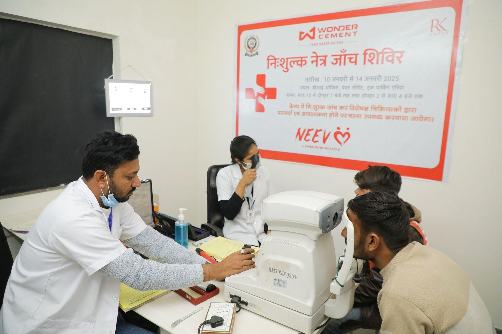 Medical professional examines a patient's eye at a free eye check-up camp.