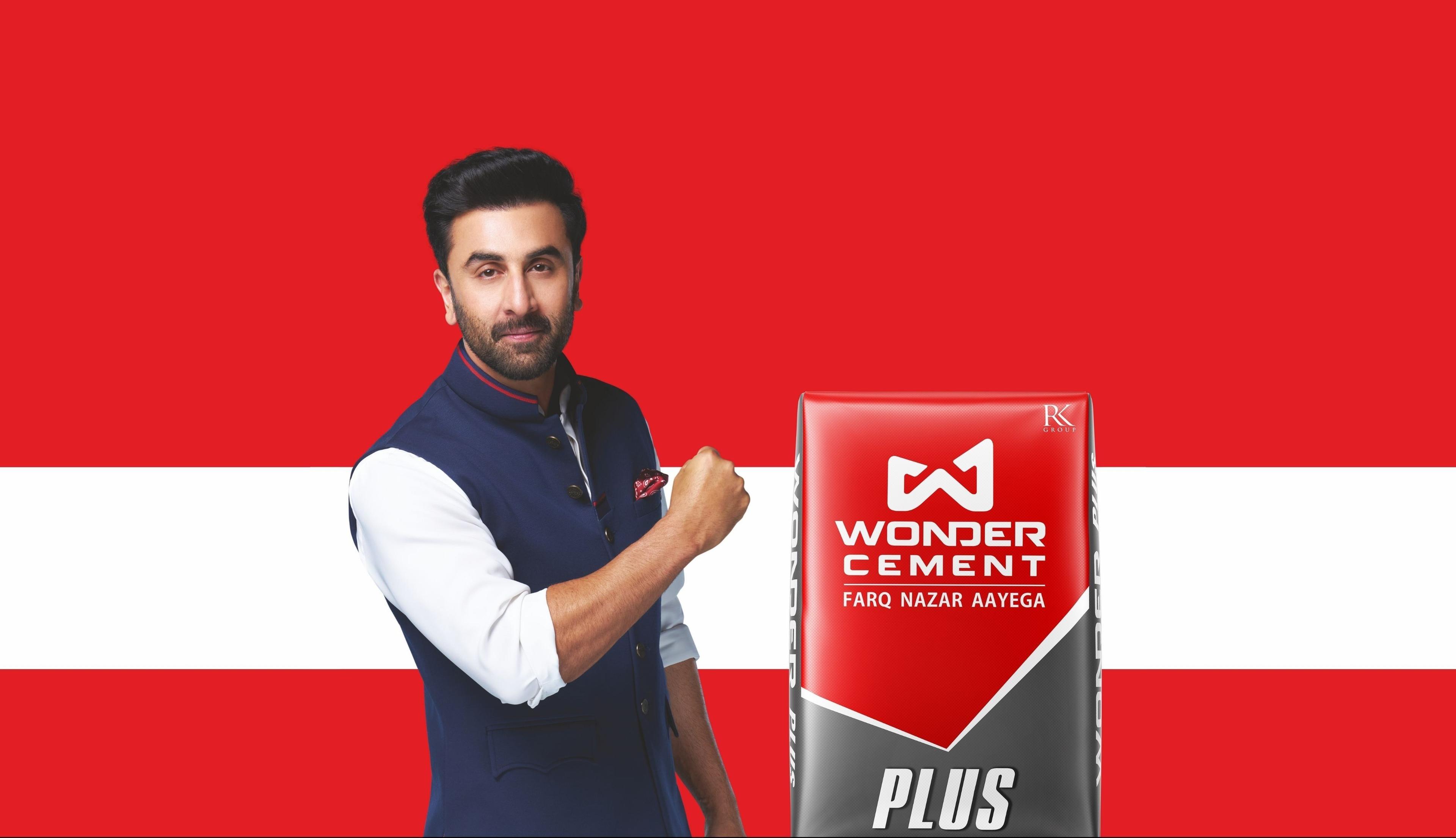 Ranbir Kapoor in a blue waistcoat stands next to a Wonder Cement Plus bag.